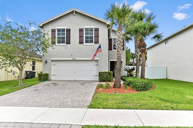 6143 Wildfire Way, West Palm Beach, FL 33415 - view of front of home featuring stucco siding, decorative driveway, and an attached garage