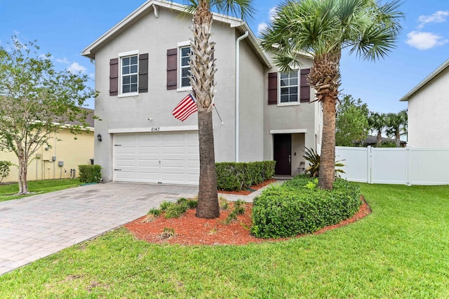 6143 Wildfire Way, West Palm Beach, FL 33415 - view of front of property with a garage, stucco siding, and decorative driveway