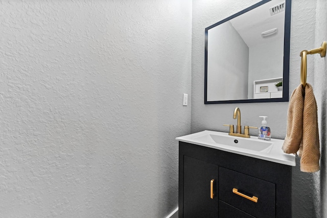 6143 Wildfire Way, West Palm Beach, FL 33415 - bathroom featuring a textured wall and vanity