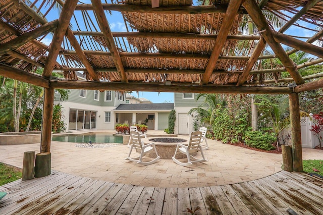 101 Saint Pierre Way, Jupiter, FL 33458 - wooden deck featuring a gazebo, an outdoor pool, a patio area, and an outdoor fire pit