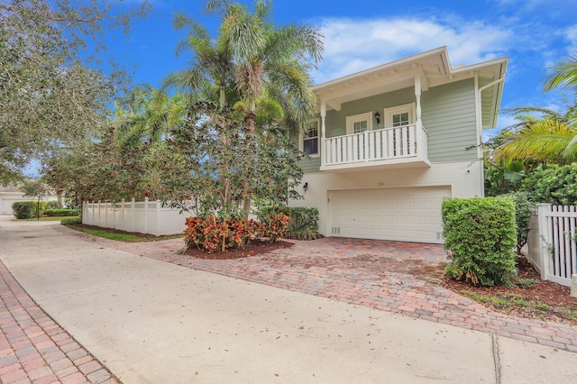 101 Saint Pierre Way, Jupiter, FL 33458 - view of front of home featuring decorative driveway, a balcony, a garage, and stucco siding