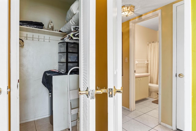 221 SE 9th Ave Unit 202, Pompano Beach, FL 33060 - walk in closet featuring tile patterned flooring
