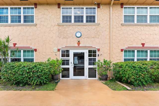 221 SE 9th Ave Unit 202, Pompano Beach, FL 33060 - view of exterior entry with stucco siding and french doors