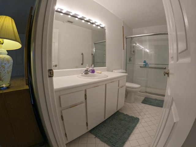 1713 Mariners Cv Unit 7C, Fort Pierce, FL 34950 - bathroom with tile patterned floors, vanity, a shower stall, and toilet
