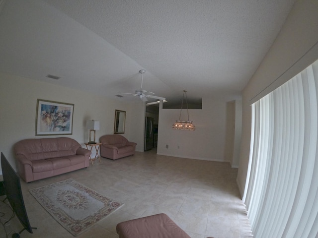 1713 Mariners Cv Unit 7C, Fort Pierce, FL 34950 - living room featuring a ceiling fan, lofted ceiling, a chandelier, and a textured ceiling