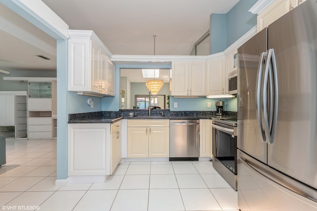 6491 Royal Manor Cir, Delray Beach, FL 33484 - kitchen with stainless steel appliances, a chandelier, a sink, white cabinets, and light tile patterned floors