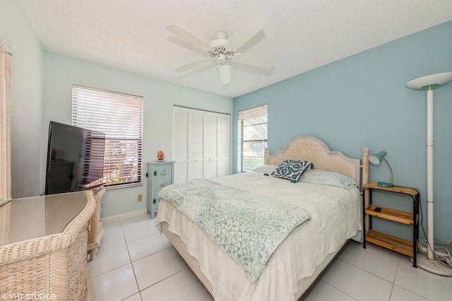 6491 Royal Manor Cir, Delray Beach, FL 33484 - bedroom featuring multiple windows, a closet, light tile patterned floors, and baseboards