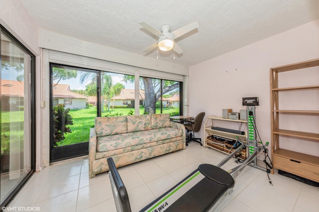 6491 Royal Manor Cir, Delray Beach, FL 33484 - exercise room featuring a ceiling fan, a textured ceiling, and light tile patterned flooring
