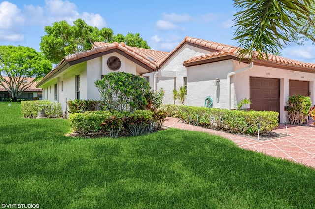 6491 Royal Manor Cir, Delray Beach, FL 33484 - mediterranean / spanish home featuring a garage, a front yard, stucco siding, and a tiled roof