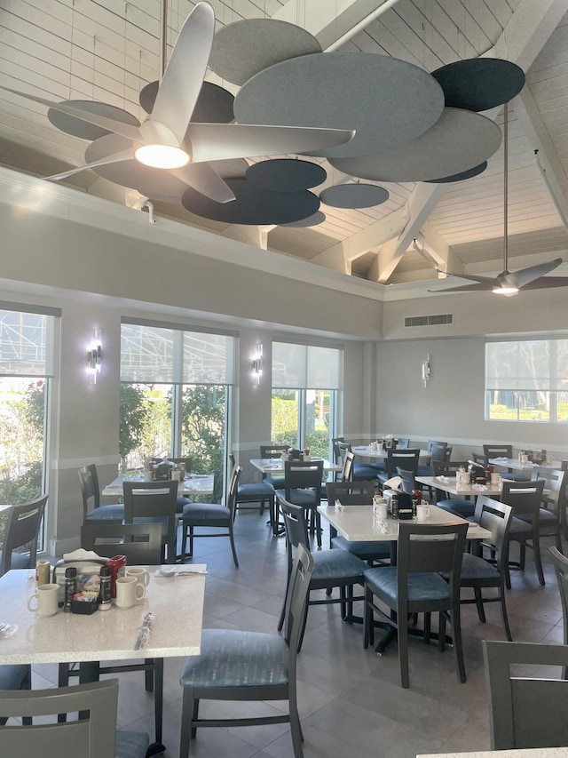 6491 Royal Manor Cir, Delray Beach, FL 33484 - dining space featuring ceiling fan, high vaulted ceiling, and beamed ceiling