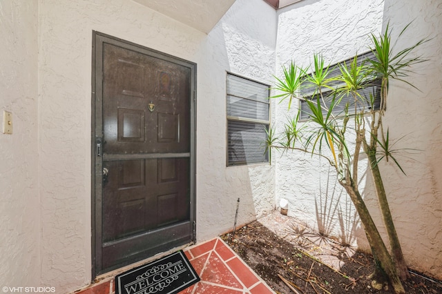6491 Royal Manor Cir, Delray Beach, FL 33484 - doorway to property featuring stucco siding
