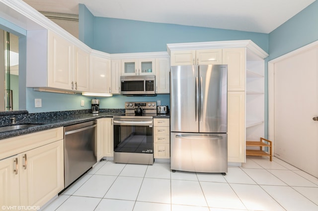 6491 Royal Manor Cir, Delray Beach, FL 33484 - kitchen featuring appliances with stainless steel finishes, lofted ceiling, glass insert cabinets, light tile patterned flooring, and a sink