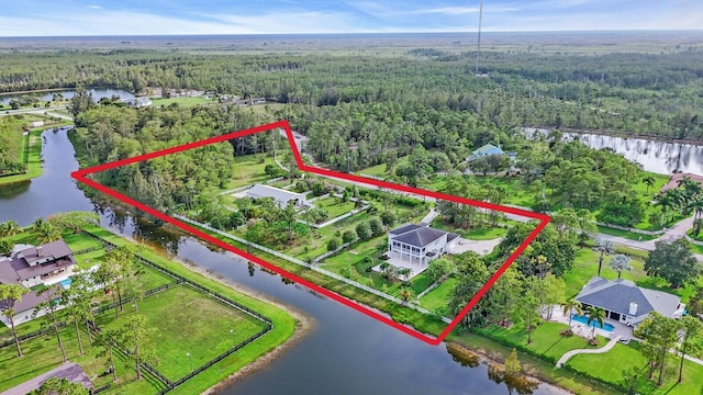 6688 Duckweed Rd, Lake Worth, FL 33449 - aerial view of property's location with a forest, property parcel outlined, and a large body of water