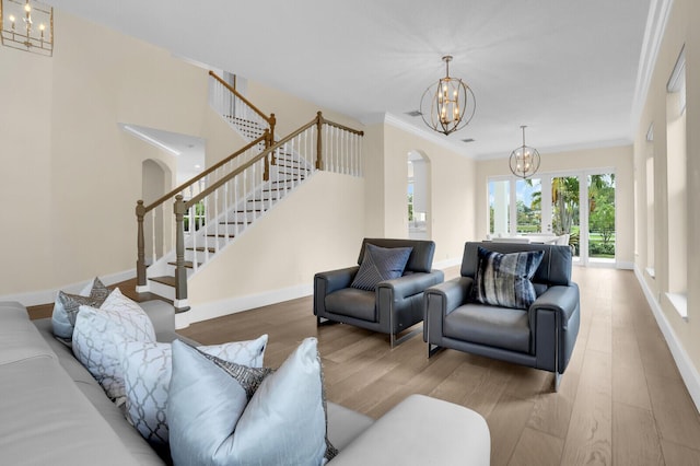 6688 Duckweed Rd, Lake Worth, FL 33449 - living area featuring arched walkways, a chandelier, wood finished floors, stairs, and ornamental molding