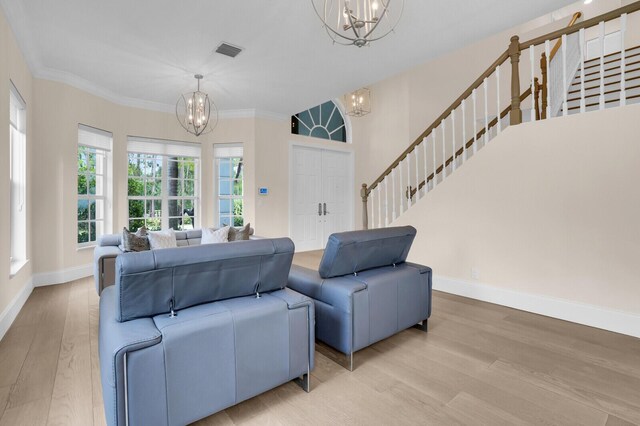 6688 Duckweed Rd, Lake Worth, FL 33449 - living area featuring a chandelier, wood finished floors, baseboards, stairway, and crown molding
