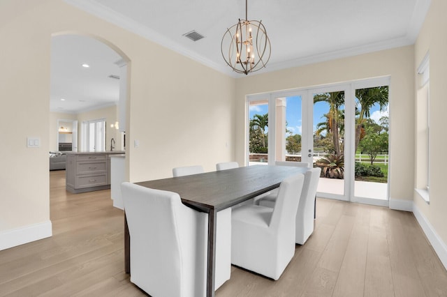 6688 Duckweed Rd, Lake Worth, FL 33449 - dining area featuring healthy amount of natural light, ornamental molding, arched walkways, light wood finished floors, and recessed lighting