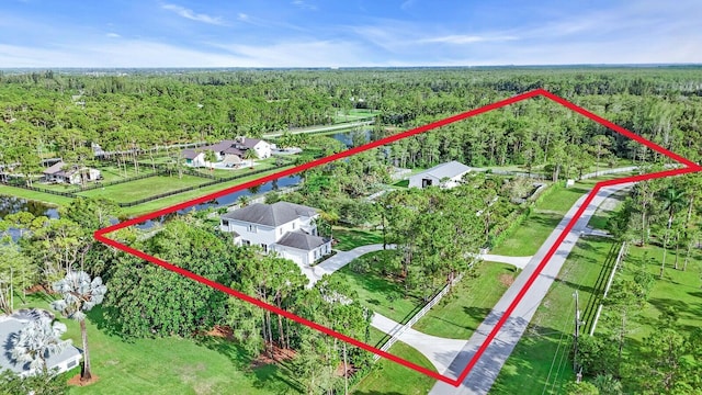 6688 Duckweed Rd, Lake Worth, FL 33449 - aerial view of property's location featuring a heavily wooded area, property parcel outlined, and a nearby body of water