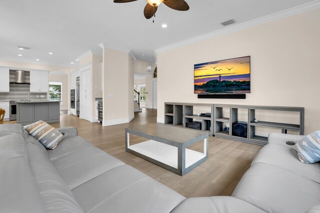 6688 Duckweed Rd, Lake Worth, FL 33449 - living room featuring crown molding, light wood-style flooring, a ceiling fan, recessed lighting, and healthy amount of natural light