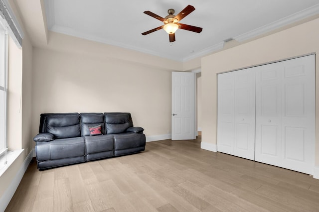 6688 Duckweed Rd, Lake Worth, FL 33449 - living room featuring a ceiling fan, light wood-style floors, crown molding, and baseboards