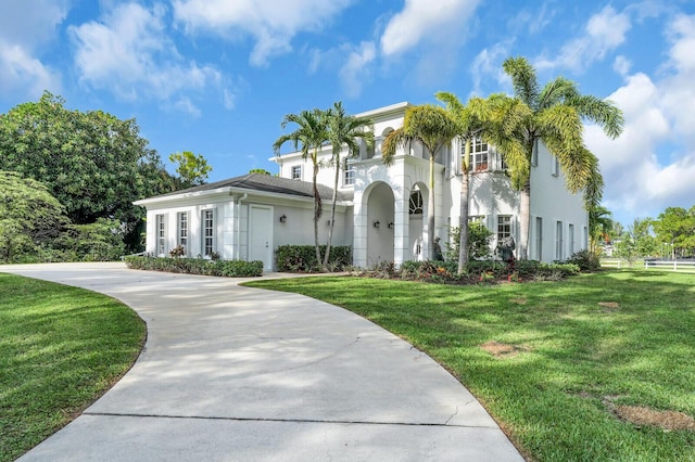 6688 Duckweed Rd, Lake Worth, FL 33449 - mediterranean / spanish house featuring stucco siding, a front yard, and driveway