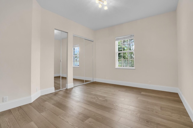 6688 Duckweed Rd, Lake Worth, FL 33449 - unfurnished bedroom featuring two closets, wood-type flooring, and baseboards