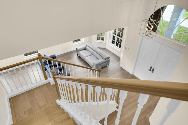 6688 Duckweed Rd, Lake Worth, FL 33449 - staircase featuring wood finished floors, plenty of natural light, and a chandelier