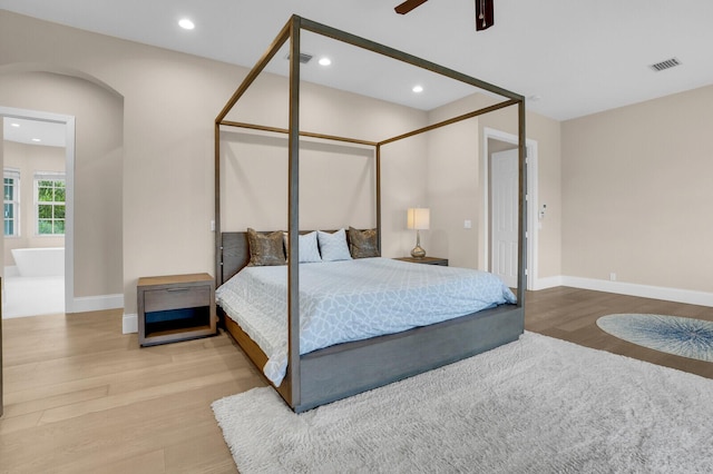 6688 Duckweed Rd, Lake Worth, FL 33449 - bedroom featuring wood finished floors, arched walkways, recessed lighting, baseboards, and a ceiling fan