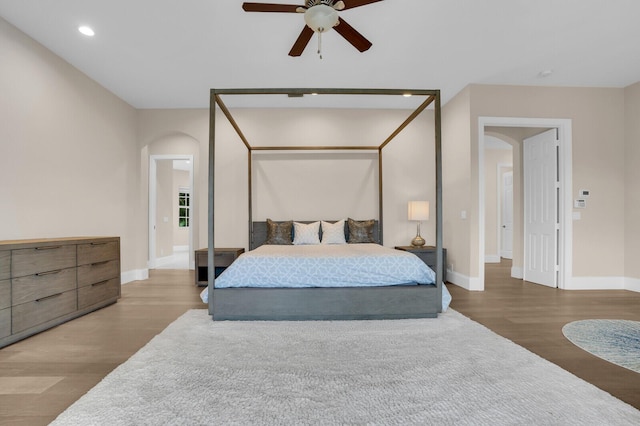 6688 Duckweed Rd, Lake Worth, FL 33449 - bedroom with arched walkways, wood finished floors, baseboards, recessed lighting, and ceiling fan