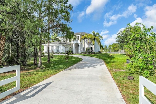 6688 Duckweed Rd, Lake Worth, FL 33449 - view of front of home featuring driveway, a front lawn, and stucco siding