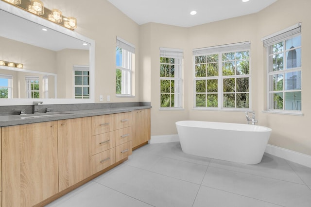 6688 Duckweed Rd, Lake Worth, FL 33449 - full bathroom with double vanity, baseboards, healthy amount of natural light, a freestanding tub, and recessed lighting