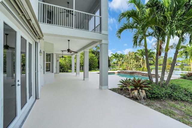 6688 Duckweed Rd, Lake Worth, FL 33449 - view of patio with ceiling fan, a balcony, and an outdoor pool