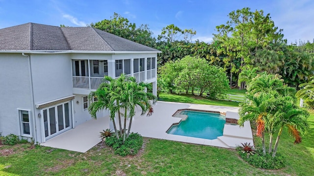 6688 Duckweed Rd, Lake Worth, FL 33449 - back of property with a patio area, a lawn, stucco siding, and roof with shingles