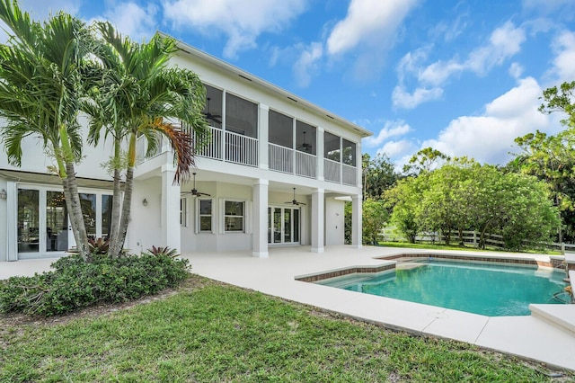 6688 Duckweed Rd, Lake Worth, FL 33449 - rear view of property featuring ceiling fan, stucco siding, a patio area, an outdoor pool, and a sunroom