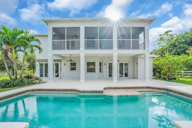 6688 Duckweed Rd, Lake Worth, FL 33449 - back of property featuring a ceiling fan, a patio area, an outdoor pool, and stucco siding