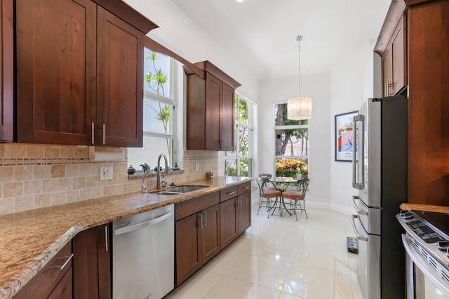 6607 NW 25th Way, Boca Raton, FL 33496 - kitchen featuring appliances with stainless steel finishes, a sink, baseboards, backsplash, and light tile patterned flooring