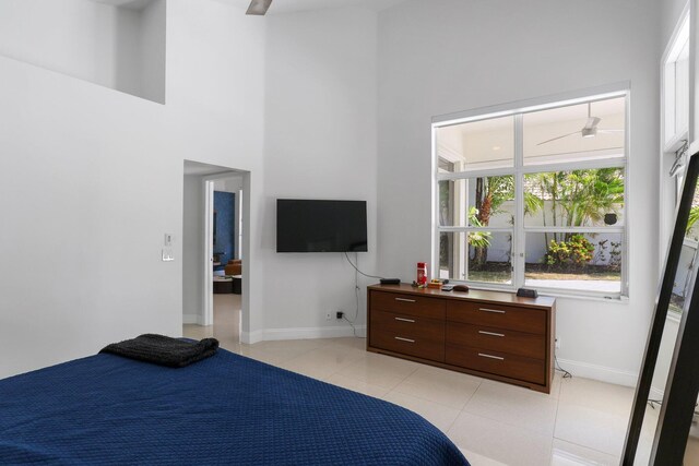 6607 NW 25th Way, Boca Raton, FL 33496 - bedroom featuring a towering ceiling, baseboards, and light tile patterned floors