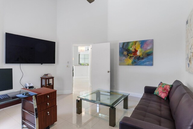 6607 NW 25th Way, Boca Raton, FL 33496 - living area with a high ceiling, light tile patterned floors, and baseboards