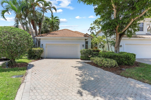 6607 NW 25th Way, Boca Raton, FL 33496 - view of front of house with a tile roof, stucco siding, decorative driveway, and a garage