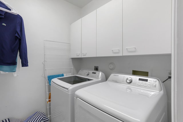 6607 NW 25th Way, Boca Raton, FL 33496 - laundry room featuring cabinet space and washer and clothes dryer