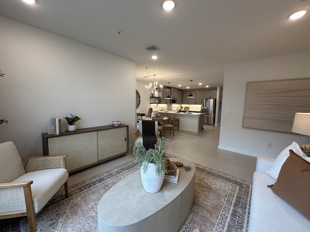 306 Silver Sands Ln Unit 17, Fort Pierce, FL 34945 - living area featuring light tile patterned floors, a chandelier, recessed lighting, and baseboards