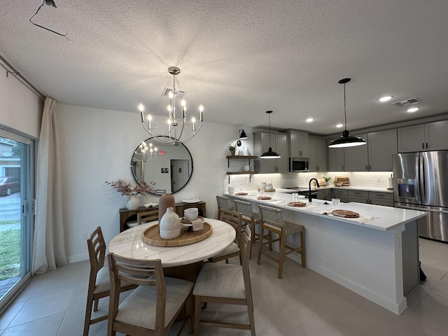 306 Silver Sands Ln Unit 17, Fort Pierce, FL 34945 - dining space with a chandelier, a textured ceiling, light tile patterned floors, and recessed lighting