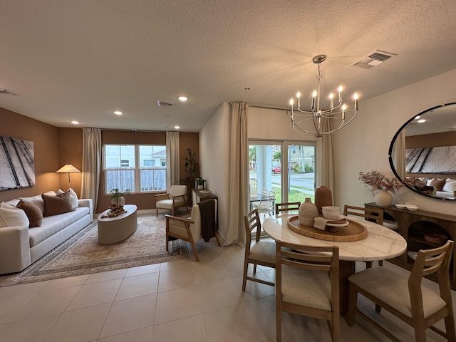 306 Silver Sands Ln Unit 17, Fort Pierce, FL 34945 - dining area featuring a chandelier, healthy amount of natural light, recessed lighting, a textured ceiling, and light tile patterned flooring