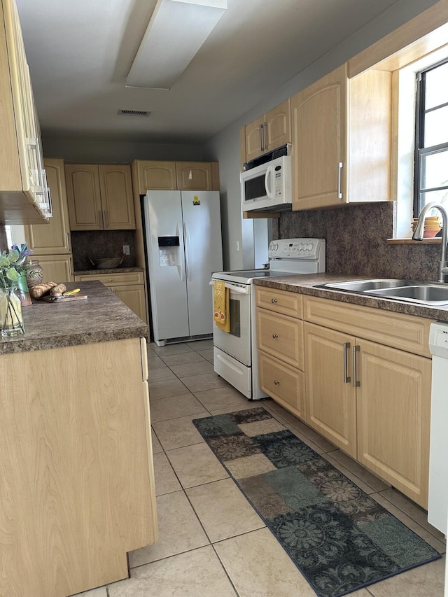 659 Snead Cir, West Palm Beach, FL 33413 - kitchen with white appliances, light brown cabinetry, a sink, and decorative backsplash