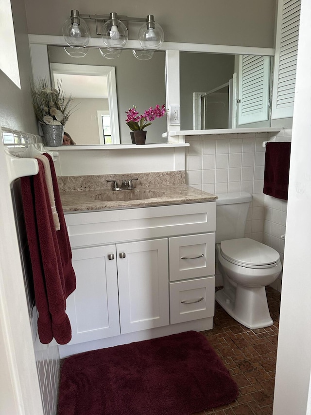 659 Snead Cir, West Palm Beach, FL 33413 - bathroom featuring vanity, brick patterned flooring, toilet, and a shower with shower door