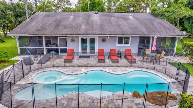 17495 40th Run N, Loxahatchee, FL 33470 - swimming pool featuring a sunroom, a patio area, and view of scattered trees