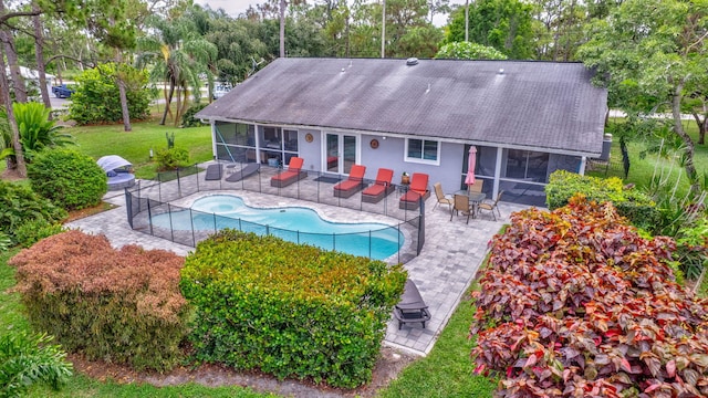 17495 40th Run N, Loxahatchee, FL 33470 - back of property with a sunroom, stucco siding, a patio area, and an outdoor pool