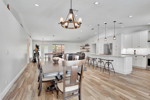 17495 40th Run N, Loxahatchee, FL 33470 - dining area featuring lofted ceiling, light wood finished floors, recessed lighting, a chandelier, and baseboards