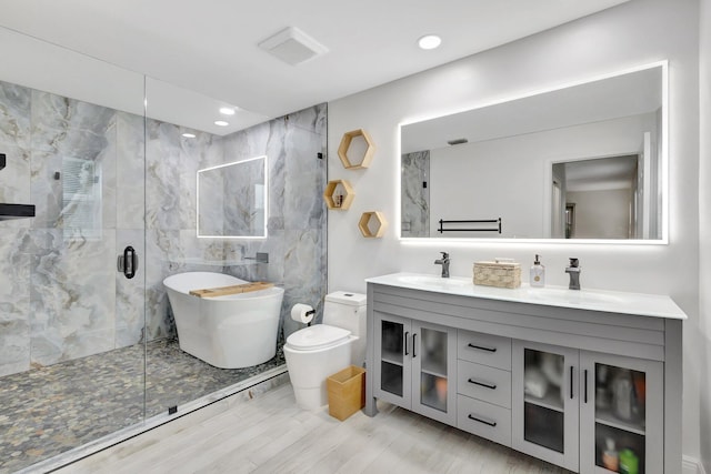 17495 40th Run N, Loxahatchee, FL 33470 - bathroom featuring double vanity, a marble finish shower, toilet, recessed lighting, and a freestanding tub