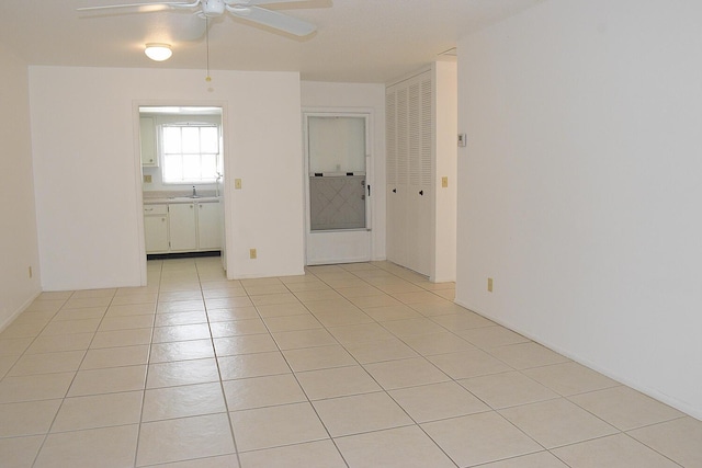 2930 Crosley Dr E Unit G, West Palm Beach, FL 33415 - unfurnished room featuring ceiling fan, a sink, and light tile patterned floors