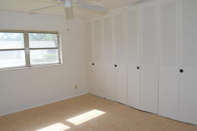 2930 Crosley Dr E Unit G, West Palm Beach, FL 33415 - unfurnished bedroom featuring light tile patterned flooring, baseboards, and a ceiling fan